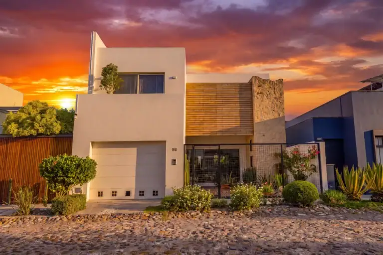 Modern white house with wooden slat paneling and desert landscaping at sunset. (informative), San Miguel de Allende