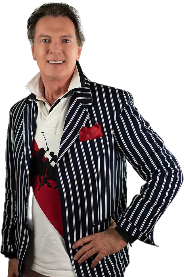 Portrait of a man in a navy pinstripe blazer with a red pocket square, white shirt, and his hand on his hip, posing confidently.
