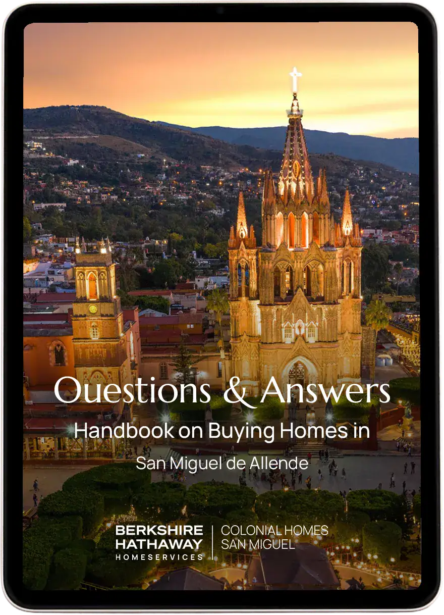 Cover image for a handbook: illuminated San Miguel de Allende church at sunset with the title 'Questions & Answers' and 'Handbook on Buying Homes in San Miguel de Allende' (Berkshire Hathaway Homeservices branding).