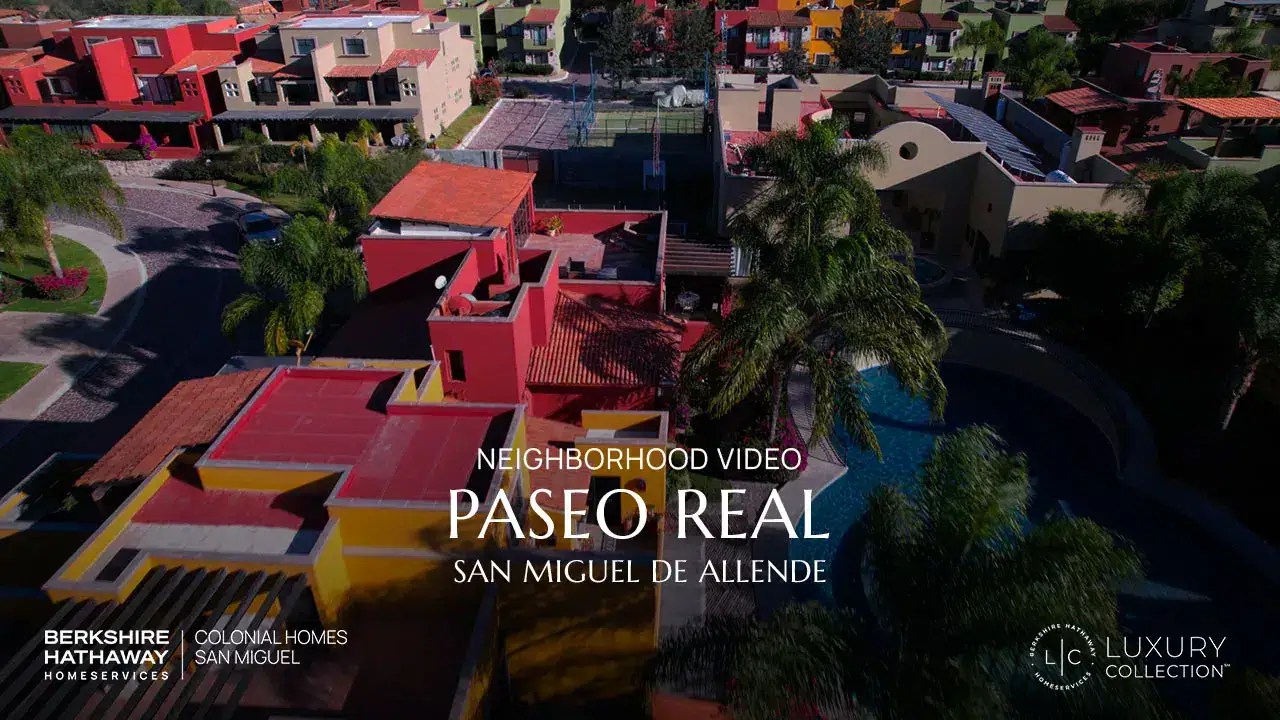 Drone view of a colorful San Miguel de Allende neighborhood; video thumbnail for the Paseo Real luxury real estate collection.