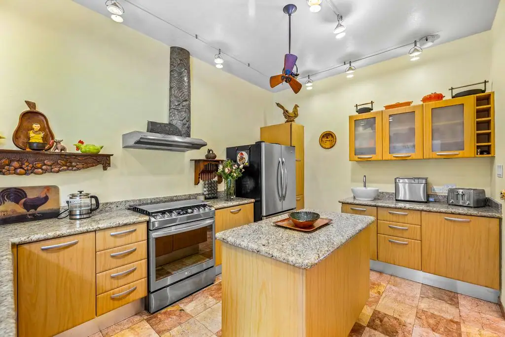 Modern kitchen with granite countertops, wood cabinets, center island, stainless steel range and fridge?, San Miguel de Allende