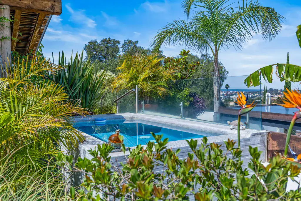 Casa Clae, swimming pool among palm trees with views toward the city, San Miguel de Allende