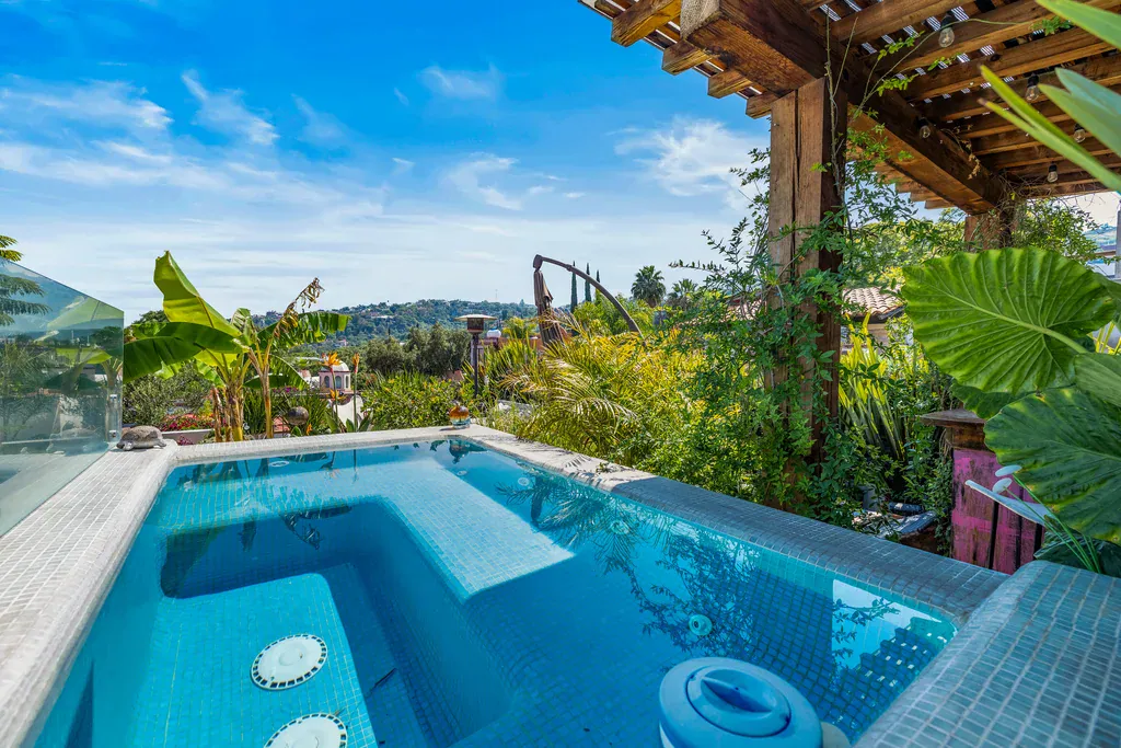 Casa Clae, rooftop plunge pool with a glass railing and tropical plants, San Miguel de Allende