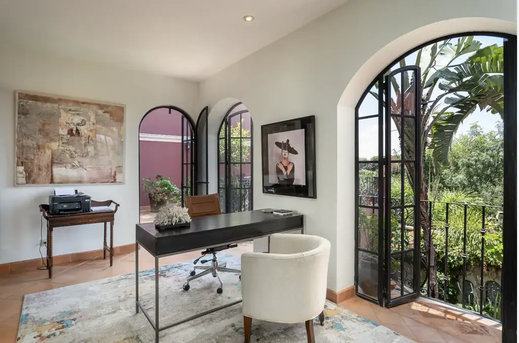 Casa del Arroyo, study with a desk, an arched window and a balcony over the garden, San Miguel de Allende