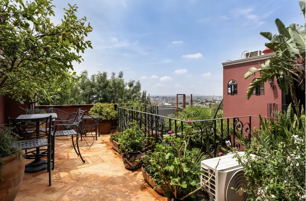 Casa del Arroyo, roof terrace railing, plants and views over the city, San Miguel de Allende