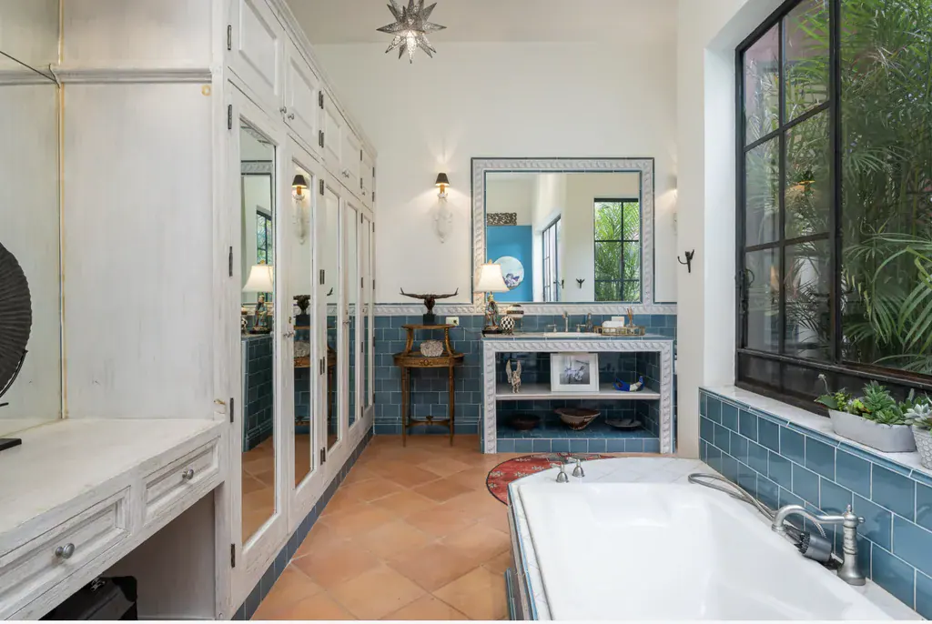 Casa del Arroyo, primary bathroom with a soaking tub, built-in cabinets and a blue tiled wall, San Miguel de Allende