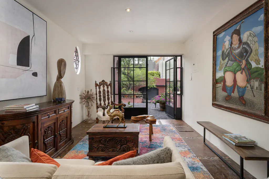 Casa del Arroyo, sitting room with carved wood furniture and a large painting, San Miguel de Allende