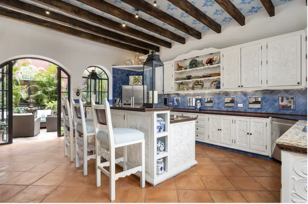 Casa del Arroyo, kitchen island and bar stools with garden doors in the background, San Miguel de Allende
