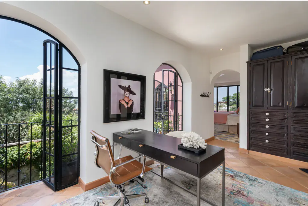 Casa del Arroyo, study with a desk and open arched balcony doors, San Miguel de Allende