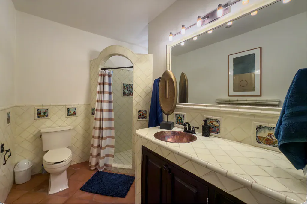 Casa del Arroyo, bathroom with a tiled vanity, a copper sink and an arched shower, San Miguel de Allende