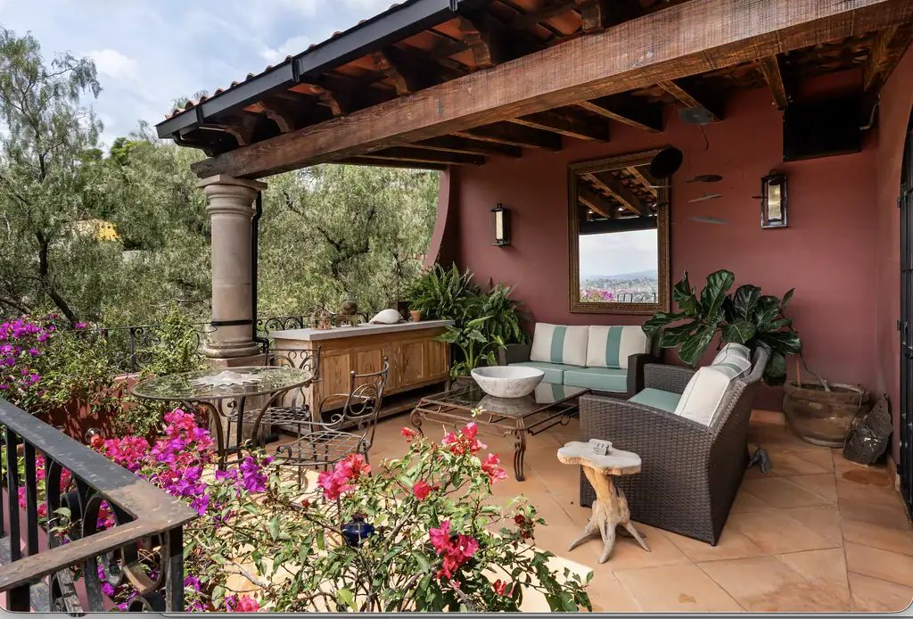 Casa del Arroyo, covered terrace with bougainvillea and a stone coffee table, San Miguel de Allende
