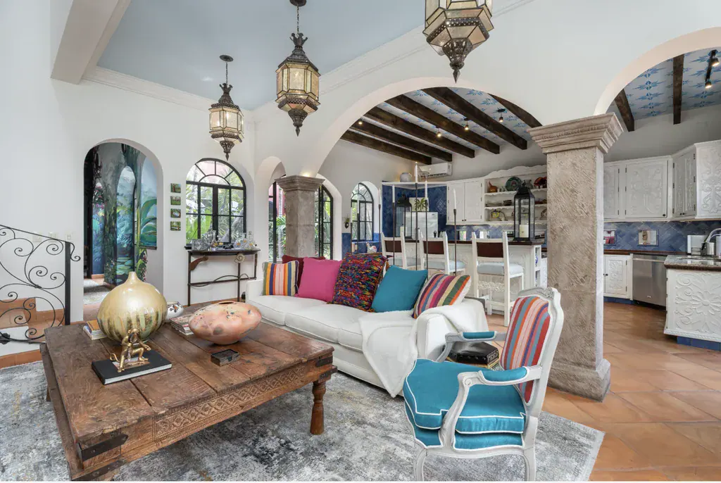 Casa del Arroyo, living room opening to the kitchen through a stone arch, San Miguel de Allende