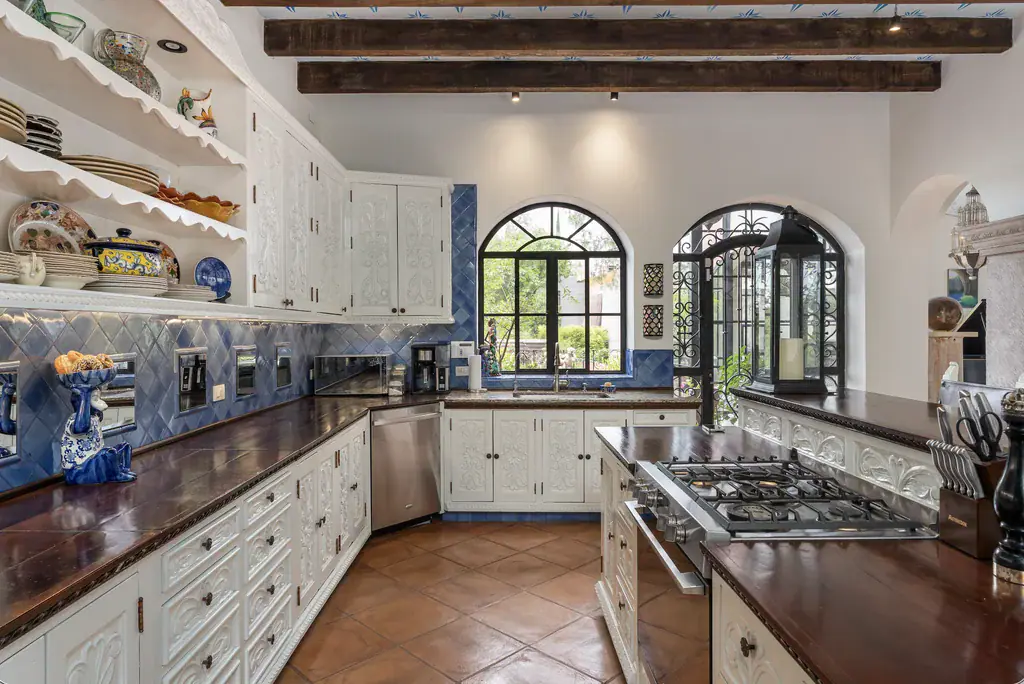 Casa del Arroyo, kitchen with white cabinets, a gas range and a blue tile backsplash, San Miguel de Allende