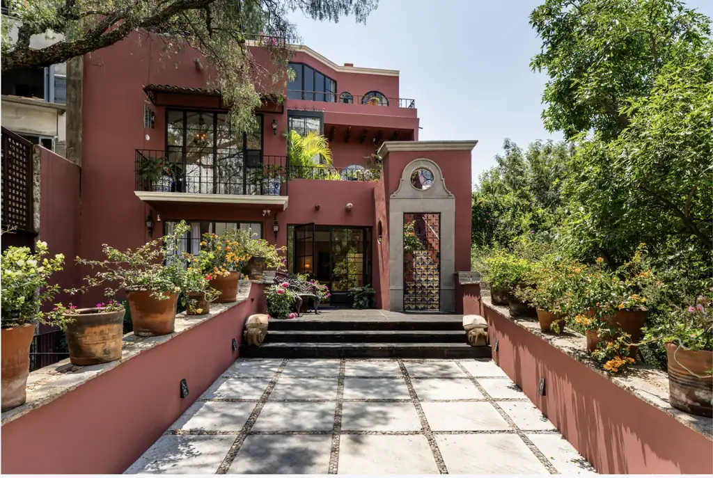 Casa del Arroyo, house facade with a paved stairway entrance and potted flowers, San Miguel de Allende