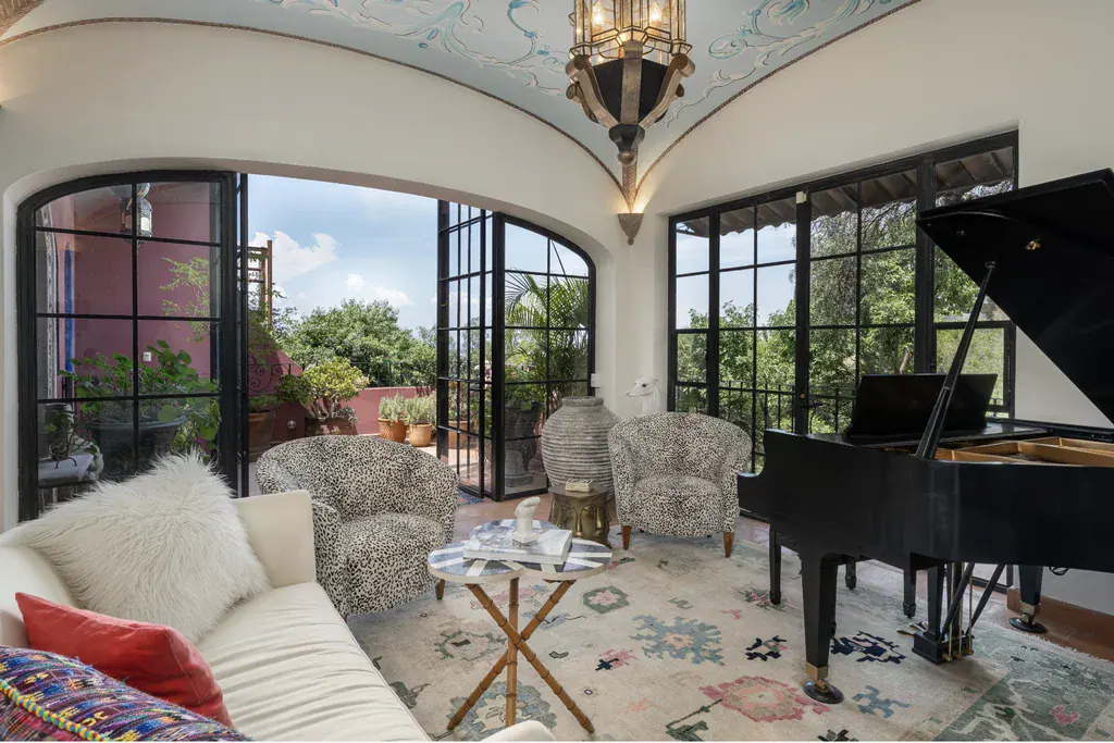Casa del Arroyo, sitting room with arched steel-framed doors and a white sofa, San Miguel de Allende