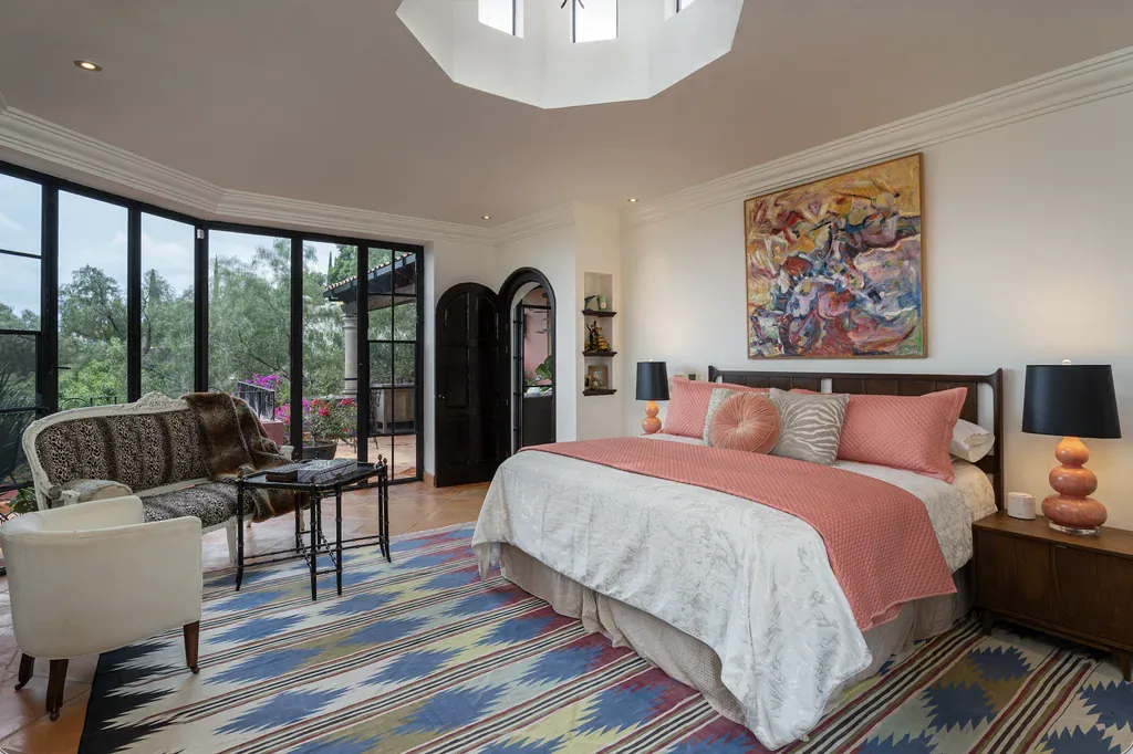 Casa del Arroyo, primary bedroom with a king bed, glass walls and a skylight, San Miguel de Allende