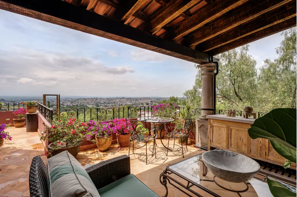 Casa del Arroyo, covered terrace with wicker seating, bougainvillea and wide views, San Miguel de Allende