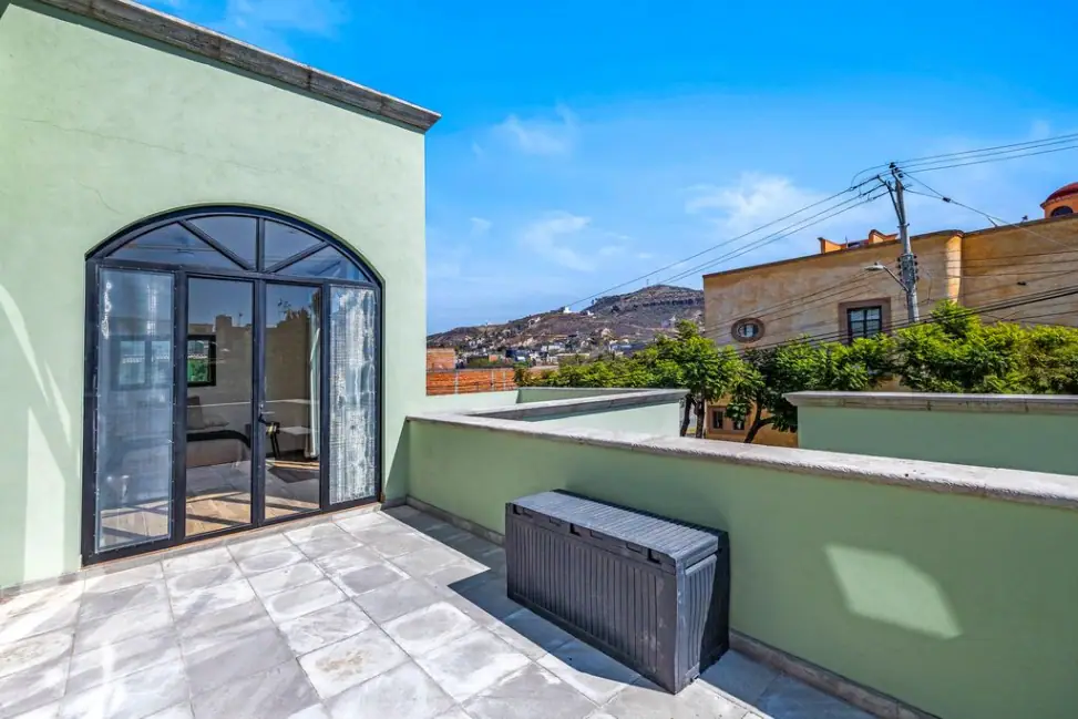 Casa Angel, roof terrace with a storage bench and views toward the hills, San Miguel de Allende