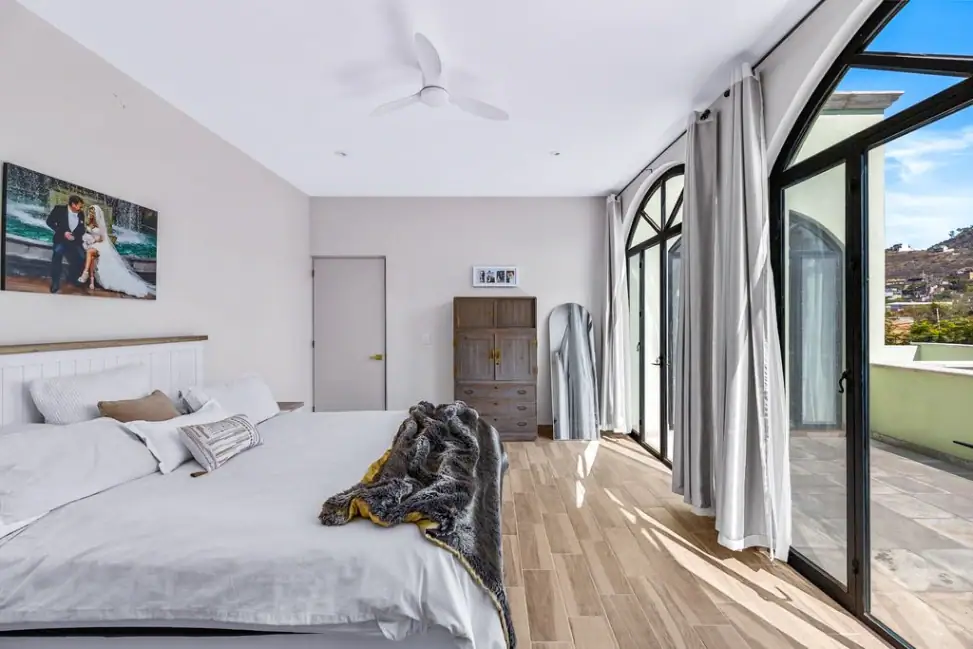 Casa Angel, primary bedroom with arched glass doors toward the terrace, San Miguel de Allende