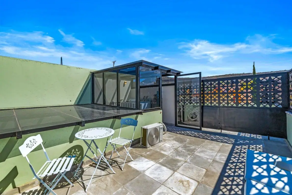 Casas Angel & Angelito, roof terrace with bistro chairs and a view over neighboring rooftops, San Miguel de Allende