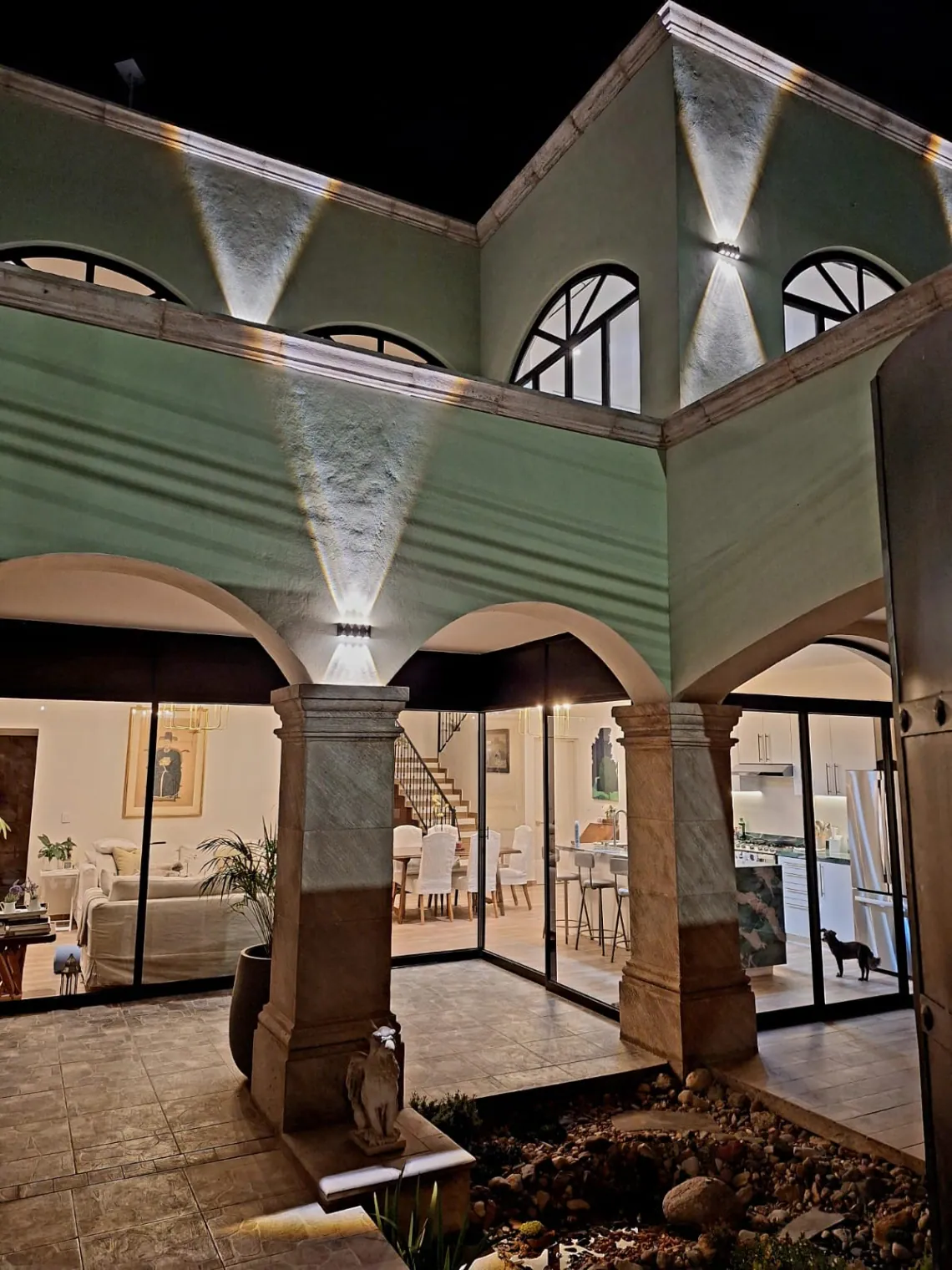 Casa Angel, courtyard arches lit at night, looking into the living room, San Miguel de Allende