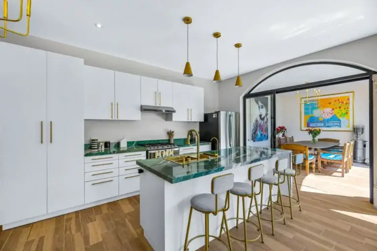 Casa Angel, kitchen with white cabinets, a green marble island and counter stools, San Miguel de Allende