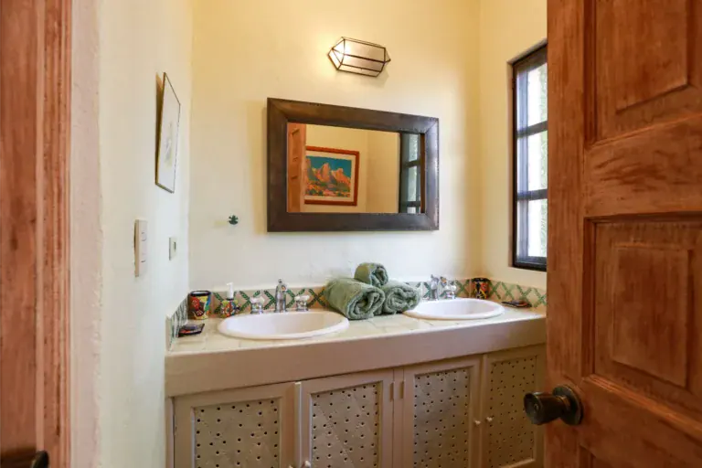 Casa Privada Baeza, bathroom with two sinks and a framed mirror, San Miguel de Allende