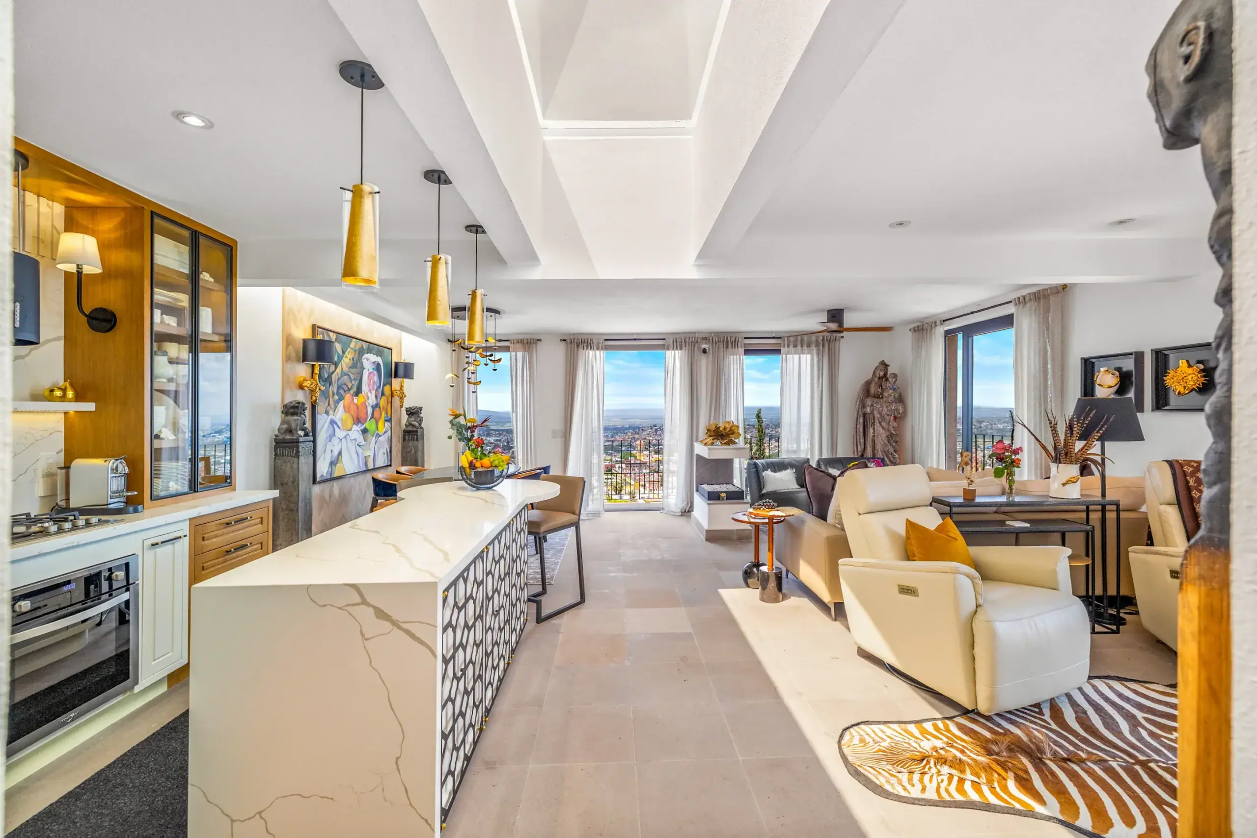 Casa Romana, kitchen and great room with a patterned counter and floor-to-ceiling city views, San Miguel de Allende