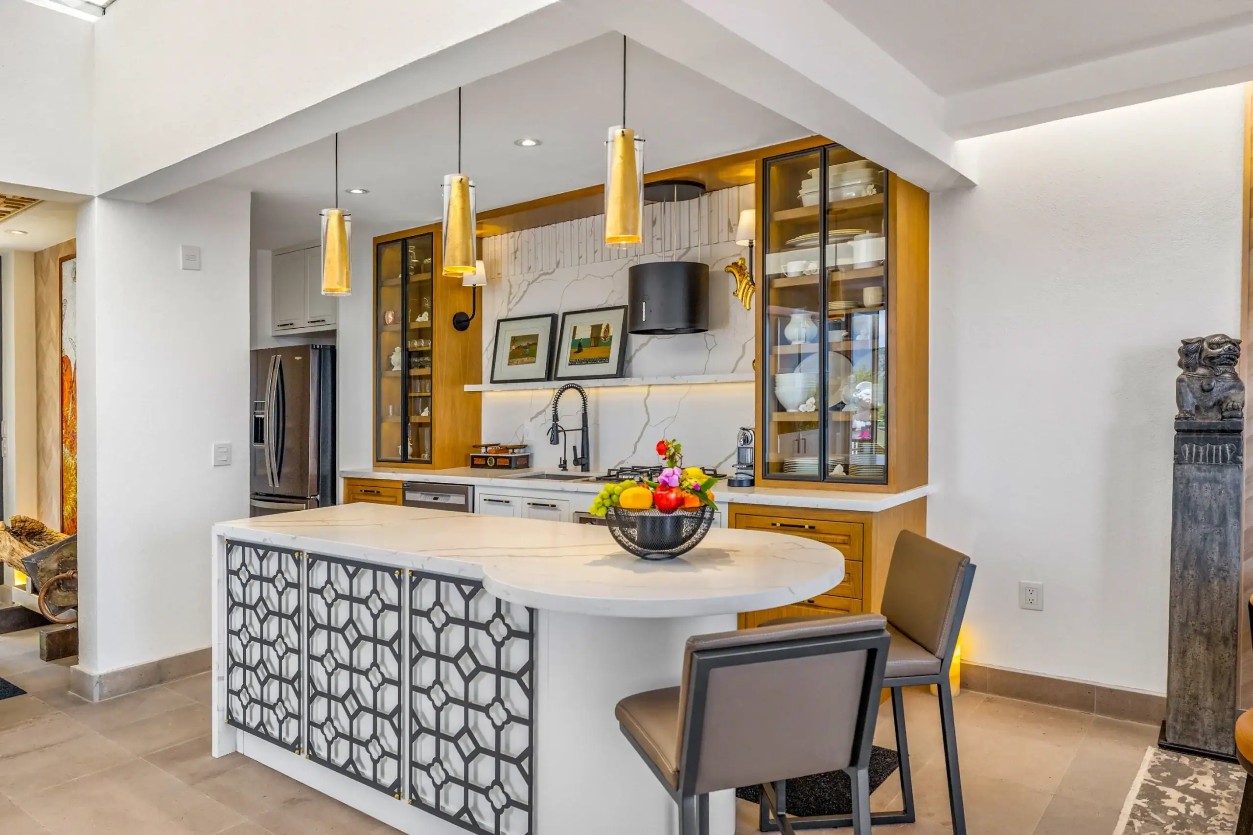 Casa Romana, kitchen with a patterned island, gold pendant lights and a glass-fronted cabinet, San Miguel de Allende