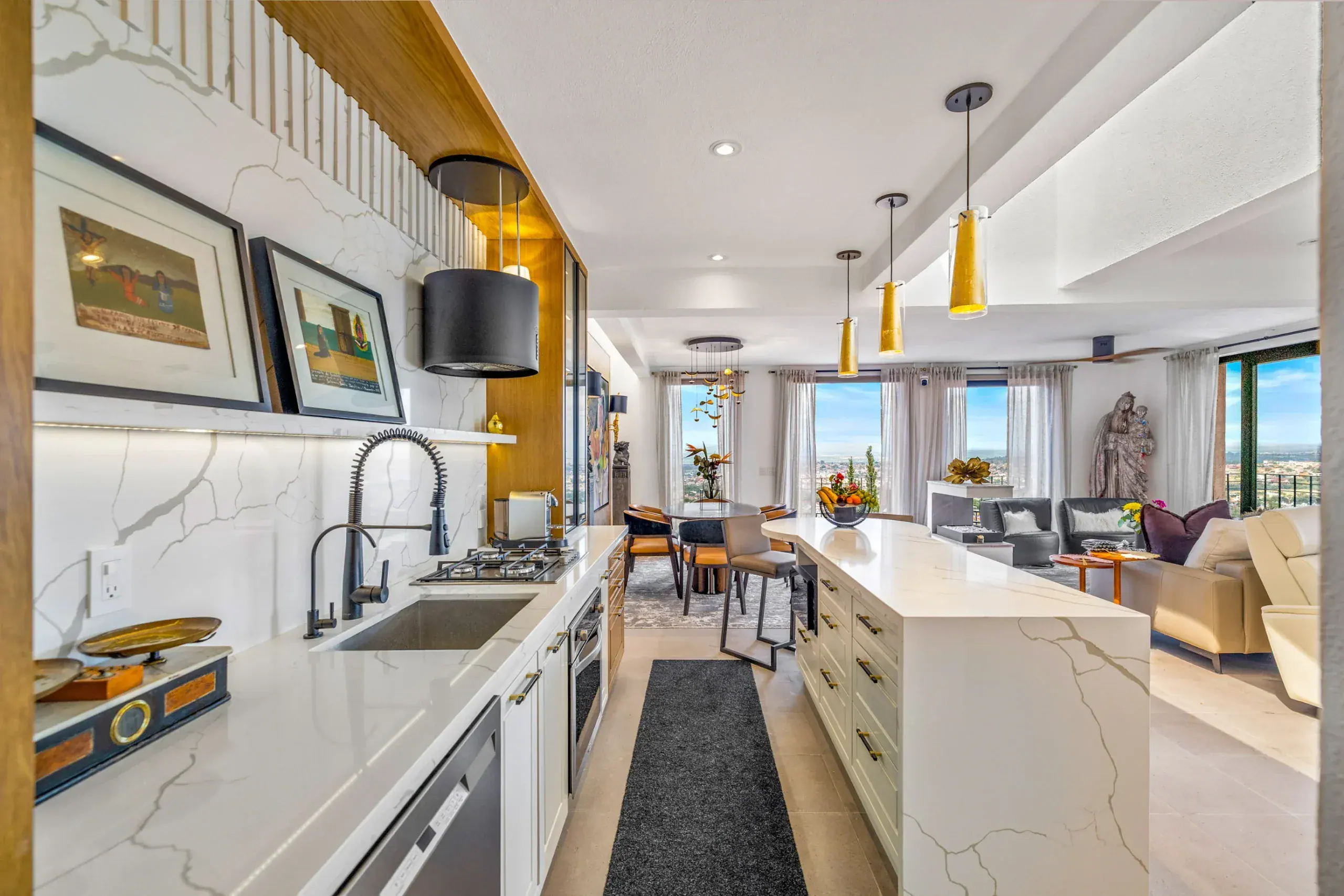 Casa Romana, galley kitchen with marble counters and a view toward the living room, San Miguel de Allende