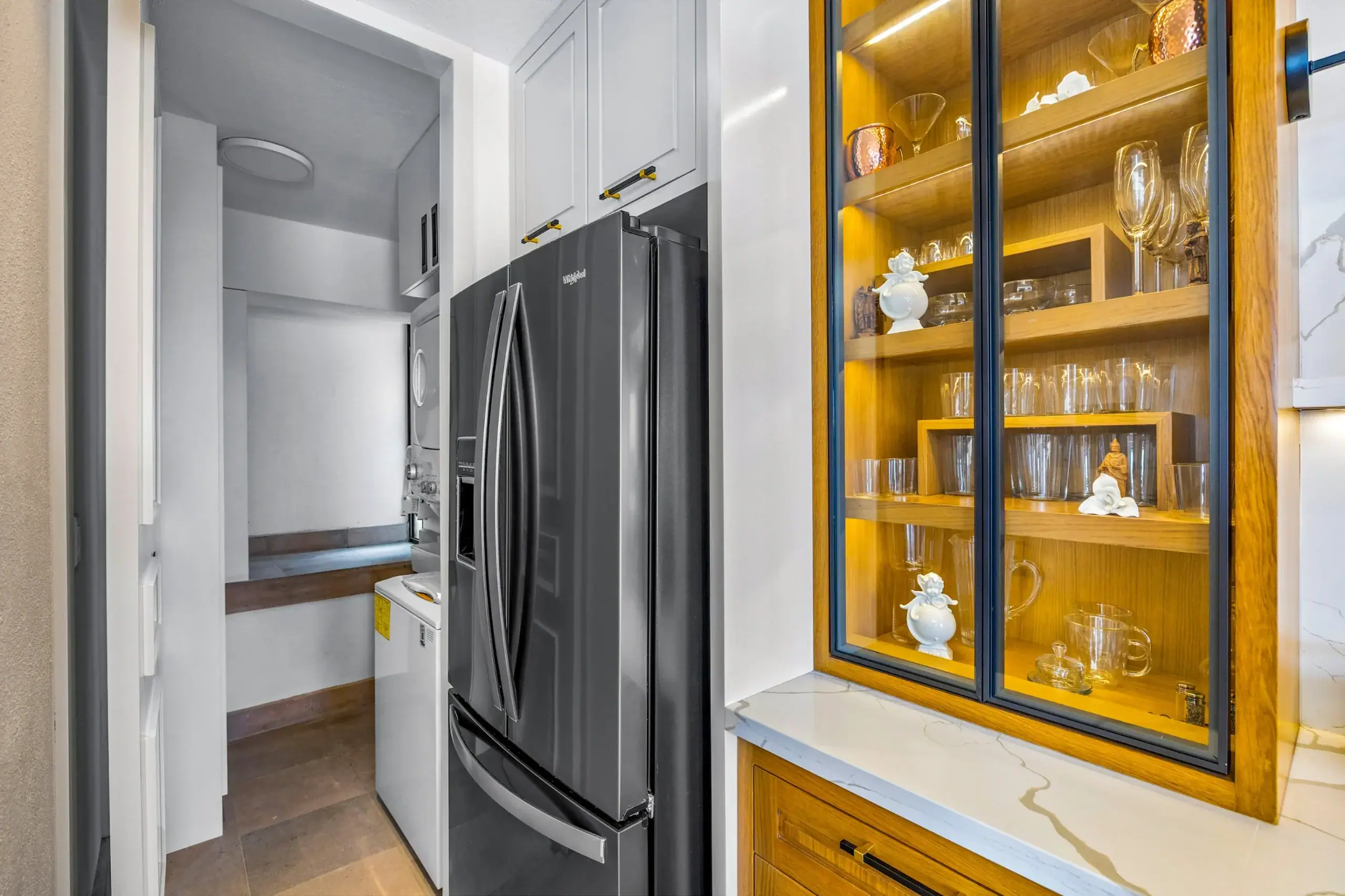 Casa Romana, pantry nook with a refrigerator beside a glass-fronted cabinet, San Miguel de Allende