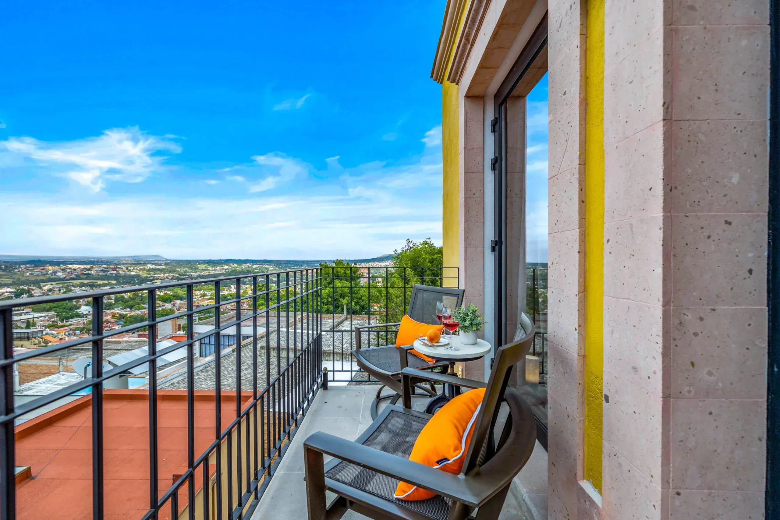 Casa Romana, balcony with seating for two overlooking the city at sunset, San Miguel de Allende