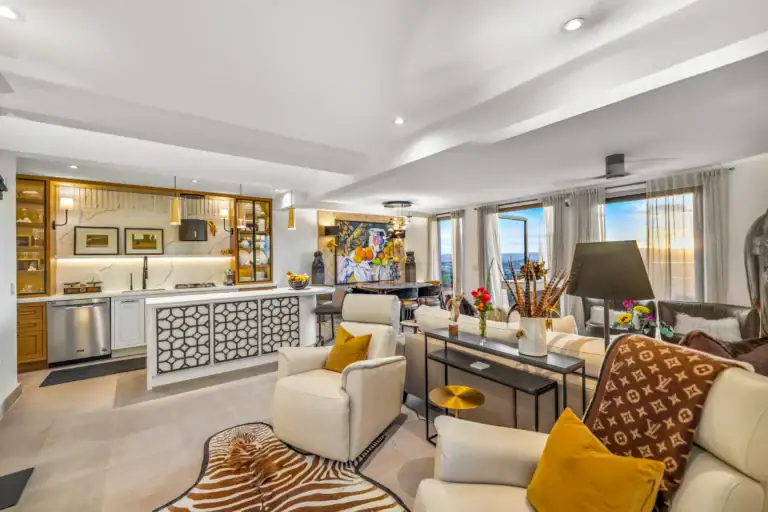 Casa Romana, living room with cream armchairs and a patterned throw, San Miguel de Allende