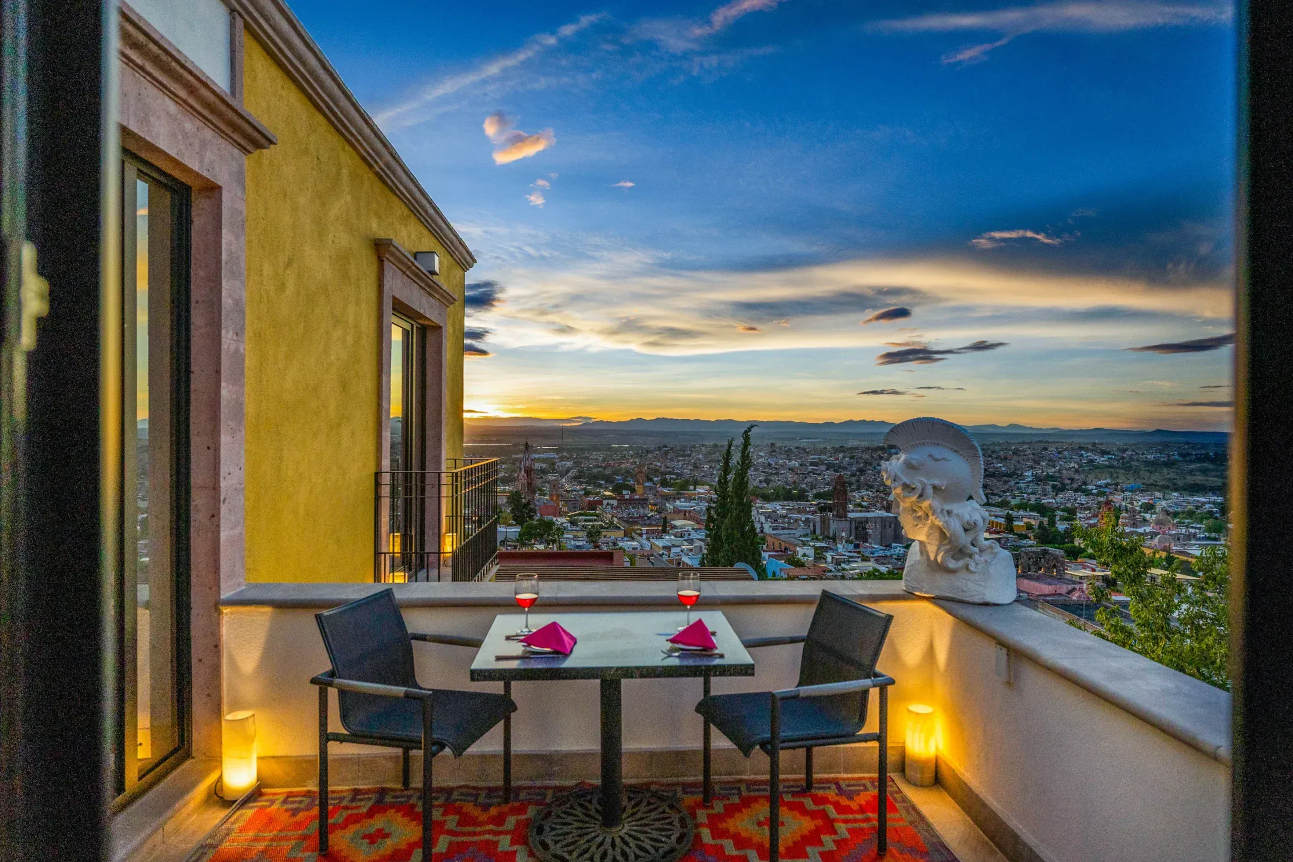 Casa Romana, terrace table at sunset above the city, San Miguel de Allende