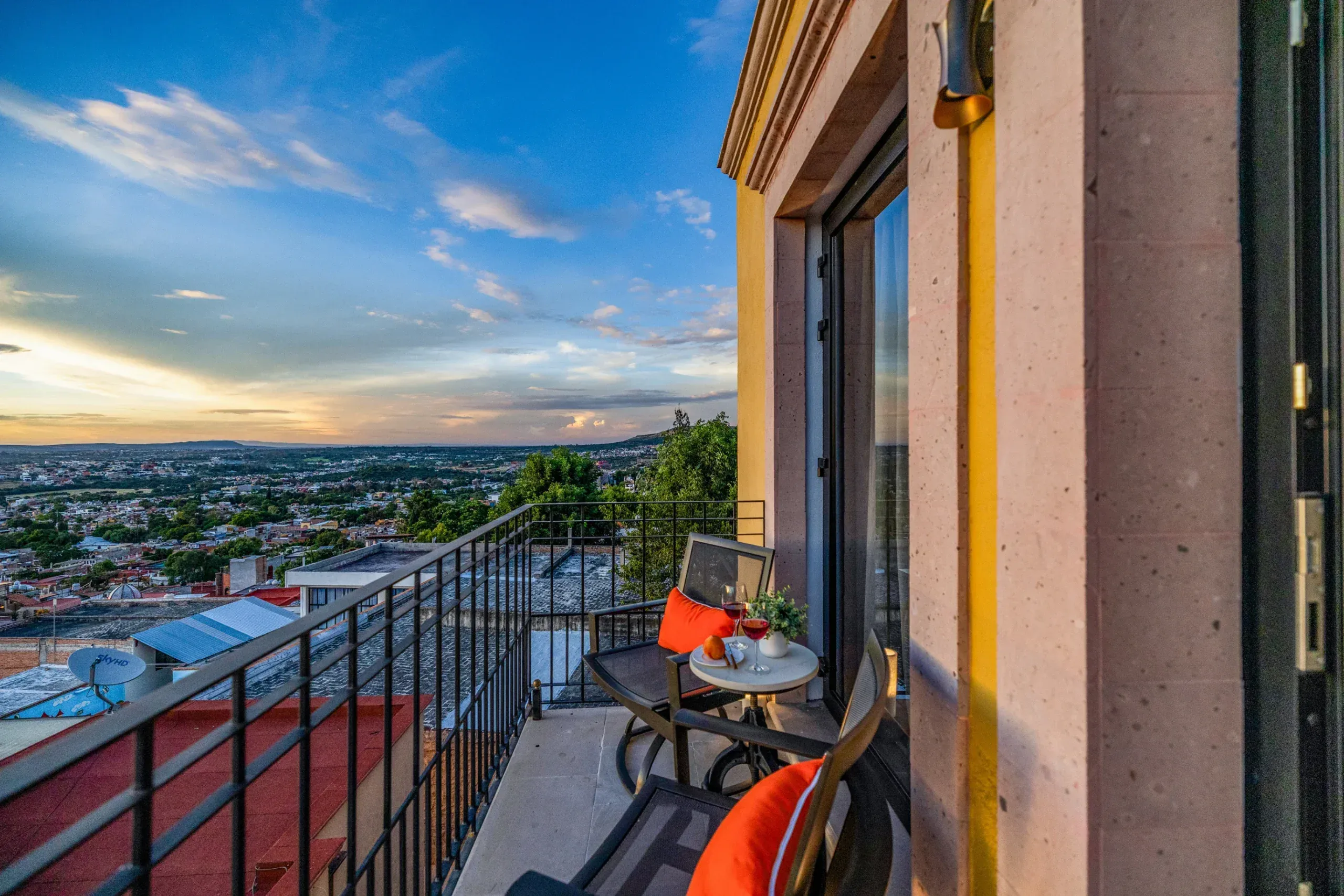 Casa Romana, balcony with a bistro table under a sunset sky, San Miguel de Allende