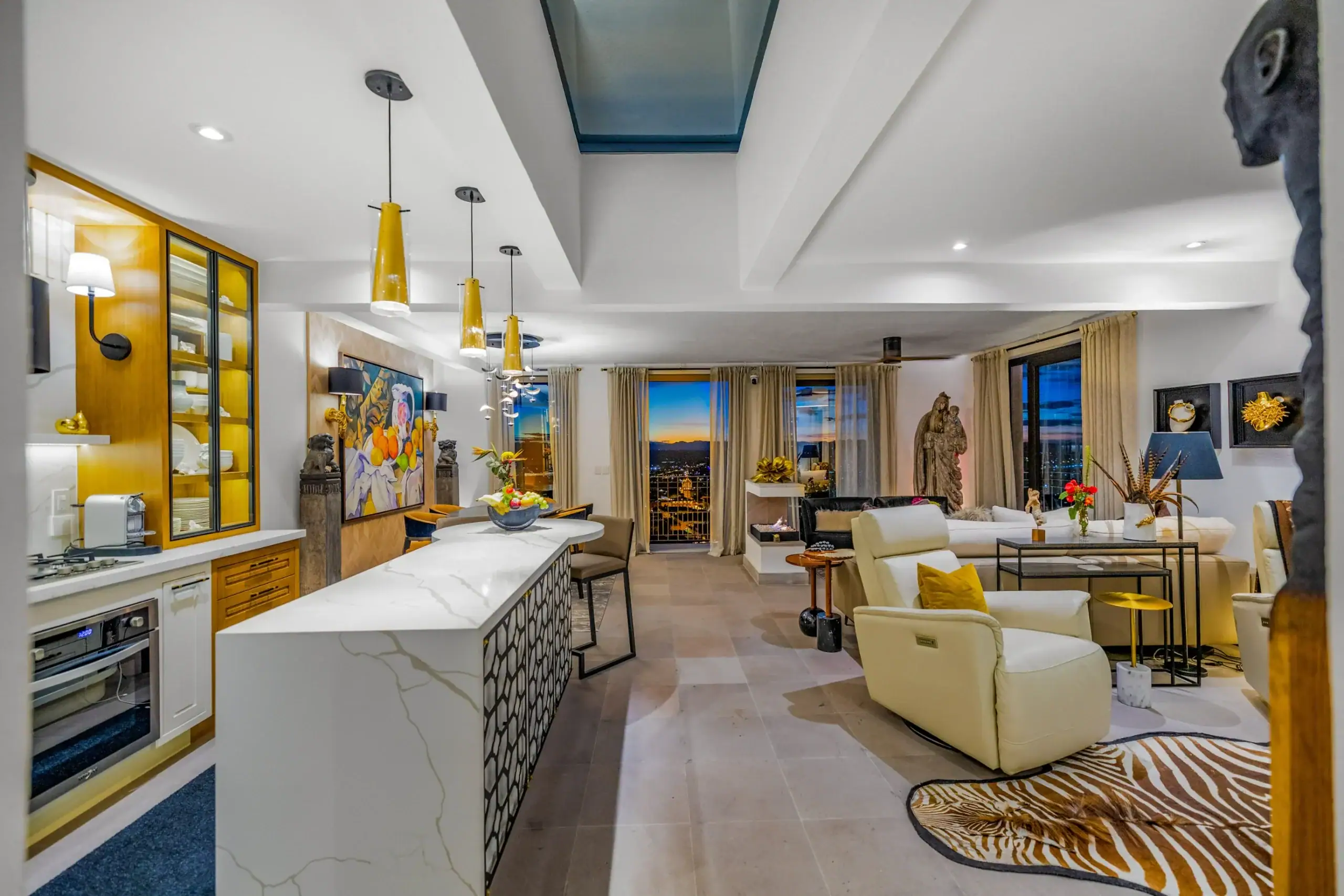 Casa Romana, great room with a skylight, a marble island and city views at dusk, San Miguel de Allende