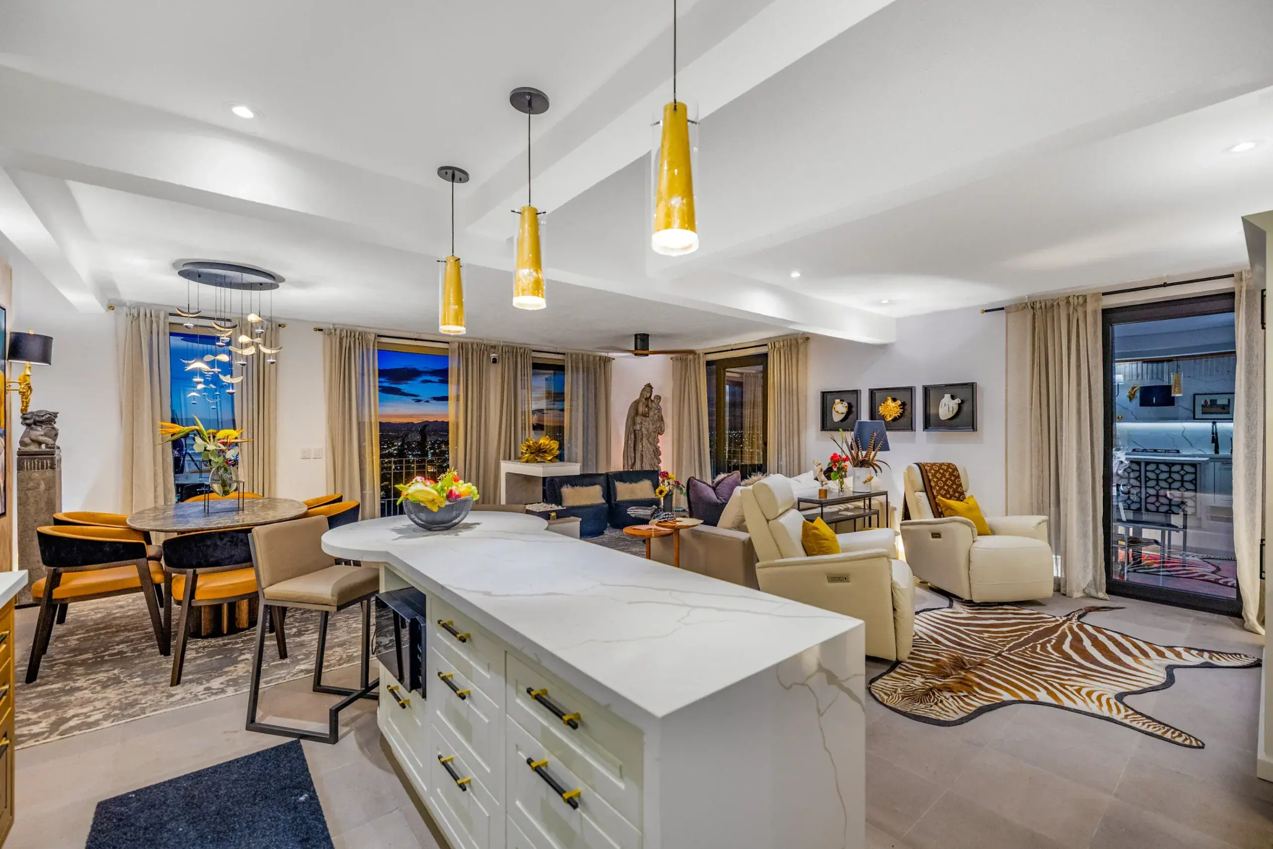 Casa Romana, dining area and kitchen island in the great room with a zebra rug, San Miguel de Allende