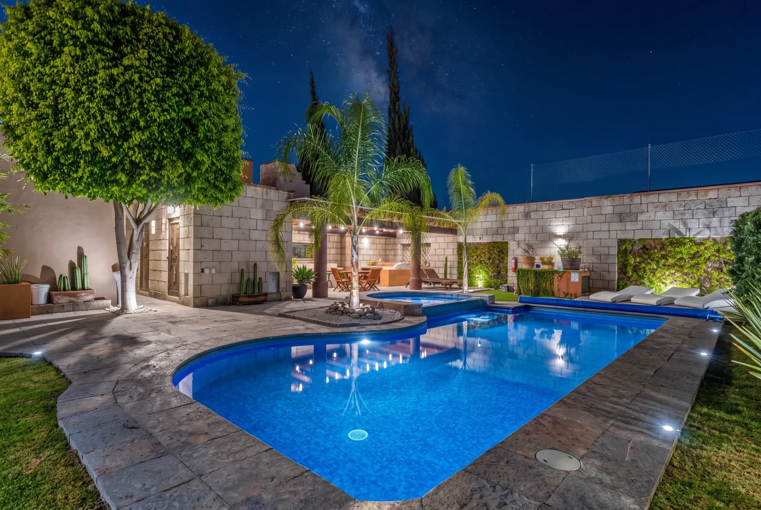 Casa Romana, swimming pool at night with garden lighting, San Miguel de Allende