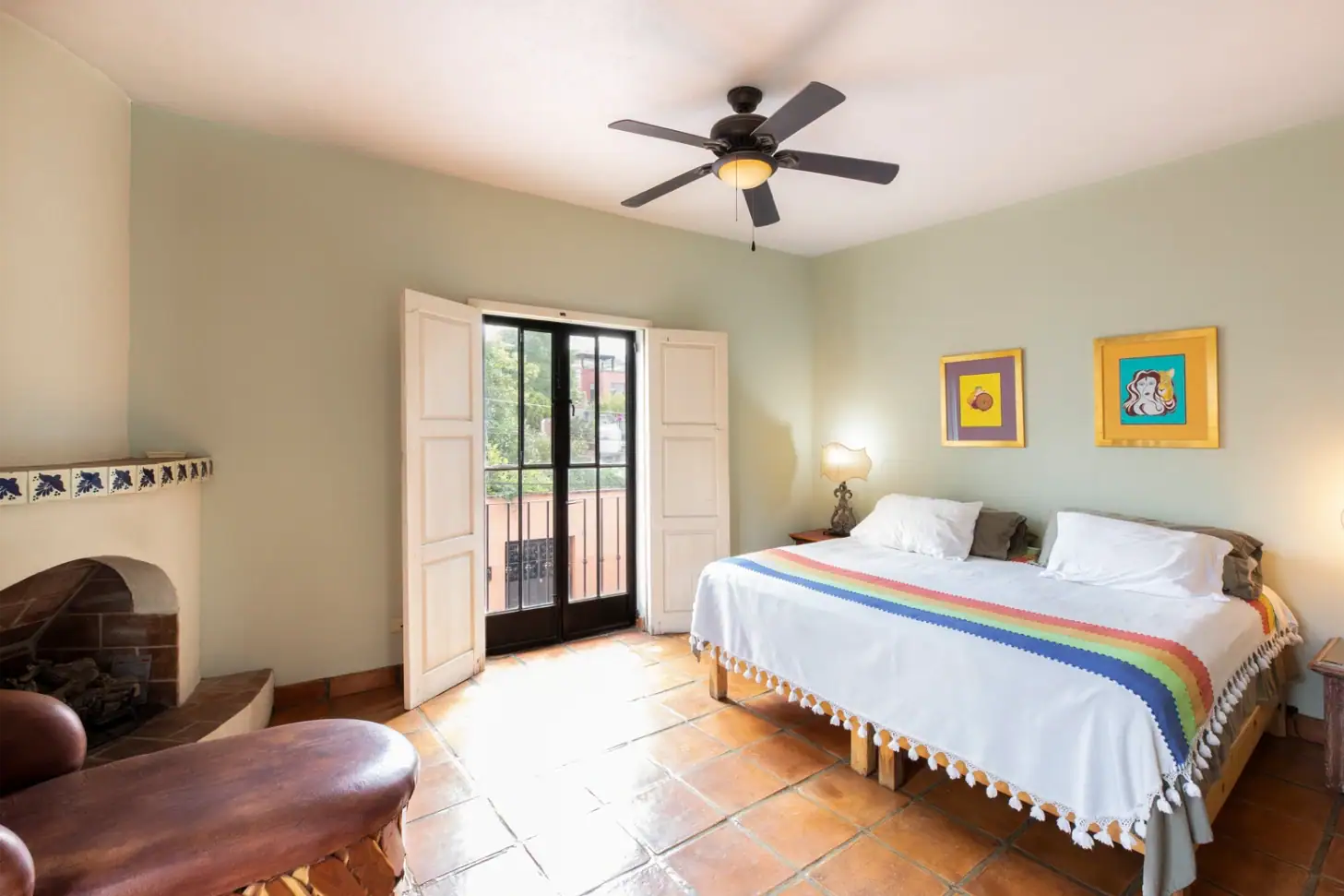 Casa Brillante, bedroom with a king bed, a corner fireplace and balcony doors, San Miguel de Allende