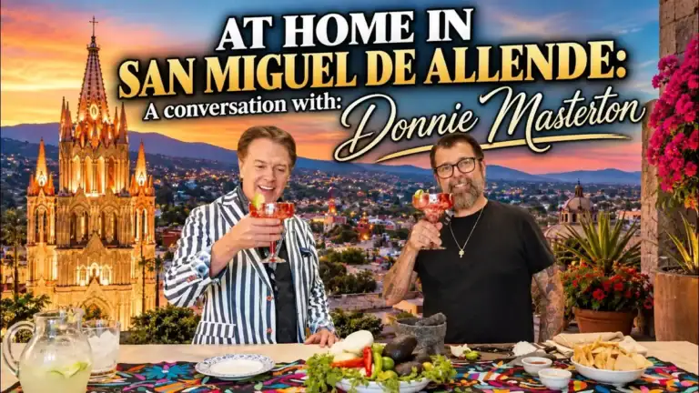 Greg Gunter and chef Donnie Masterton raising cocktails at a table of Mexican food with the Parroquia and San Miguel de Allende behind them