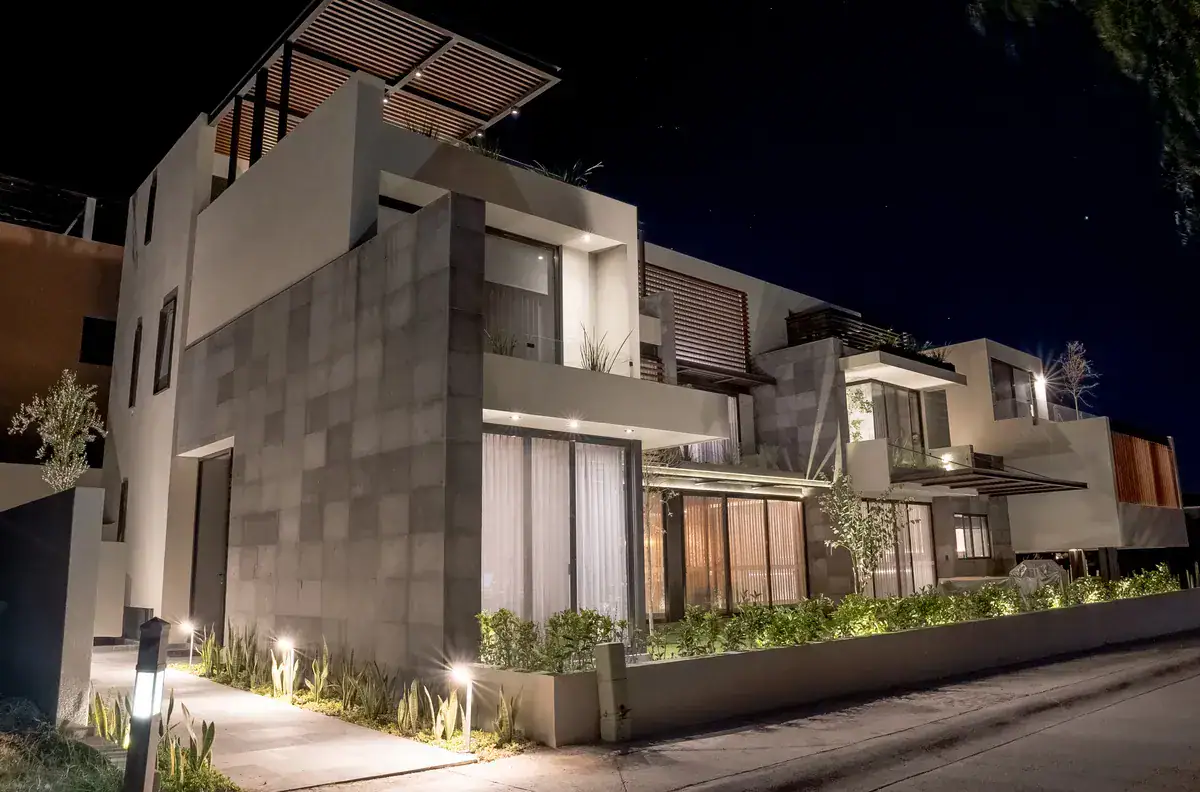 Bright House, house exterior at night with lit planters and a stone-clad facade, San Miguel de Allende