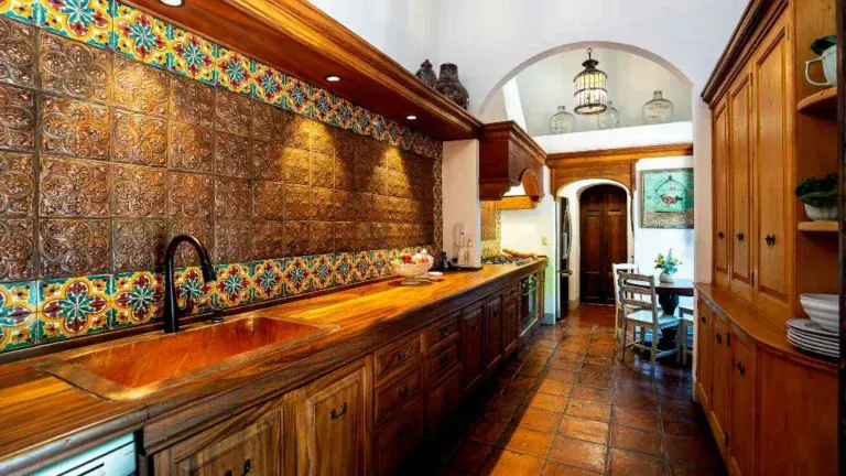 Casa Adelita, kitchen with talavera tile backsplash, wood cabinets and a copper sink, San Miguel de Allende