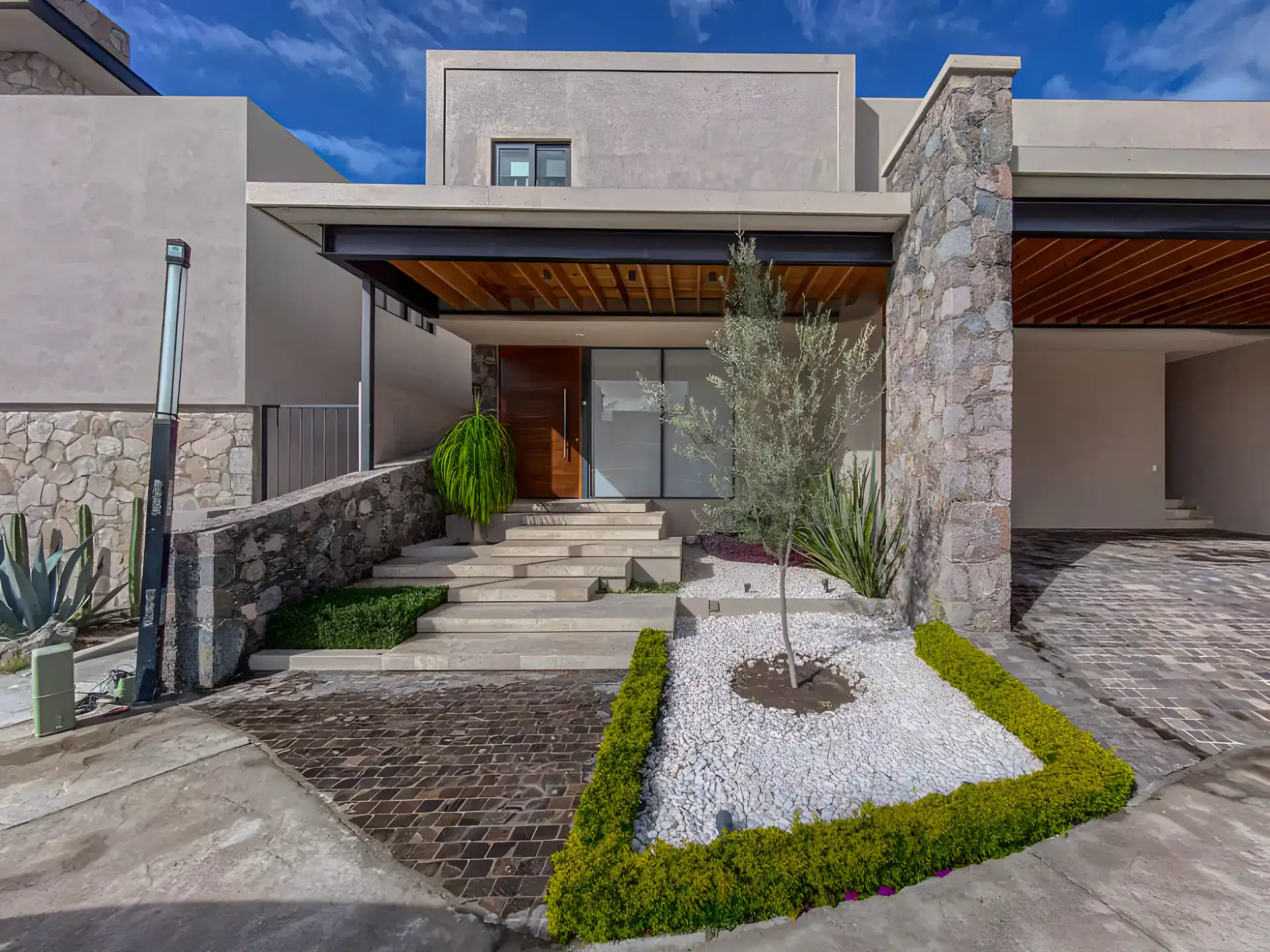 Casa Albero, stone and stucco house with a wood-ceilinged entry, a stepped walkway and a gravel garden, San Miguel de Allende