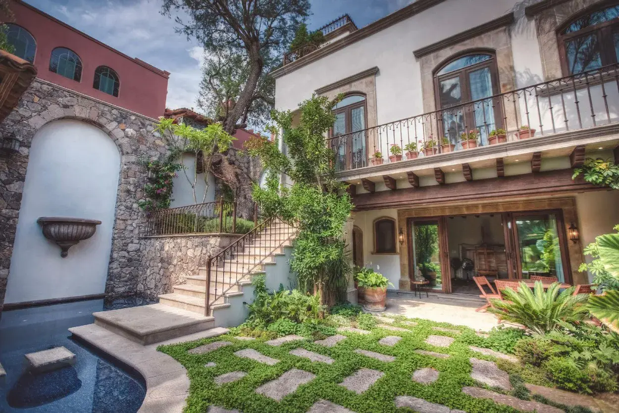 Casa Aldama, stone courtyard with a pool, outdoor stairs and a lawn, San Miguel de Allende