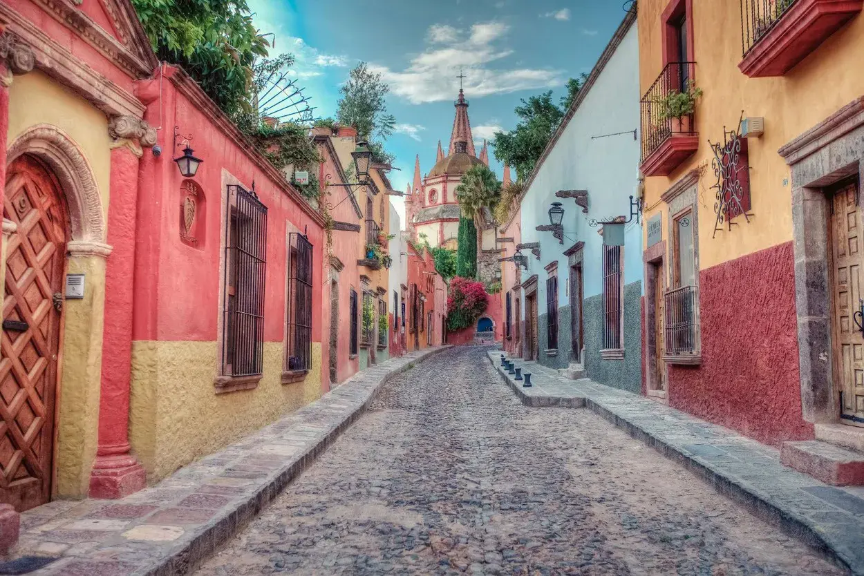Casa Aldama, cobblestone street with colorful facades and the Parroquia, San Miguel de Allende