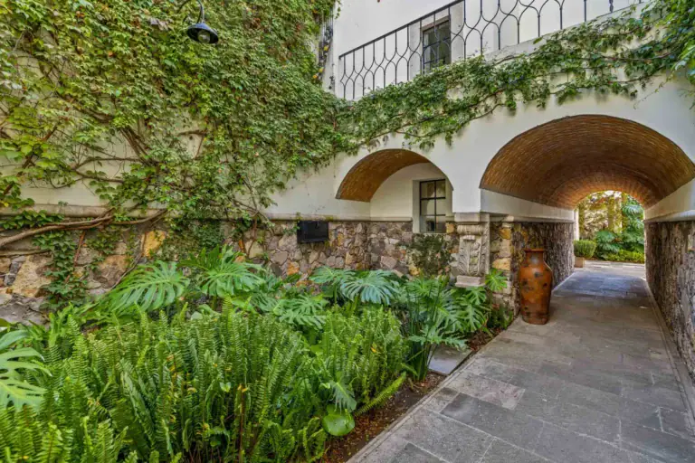 Casa Amoray, vine-covered stone arch over a garden path, San Miguel de Allende