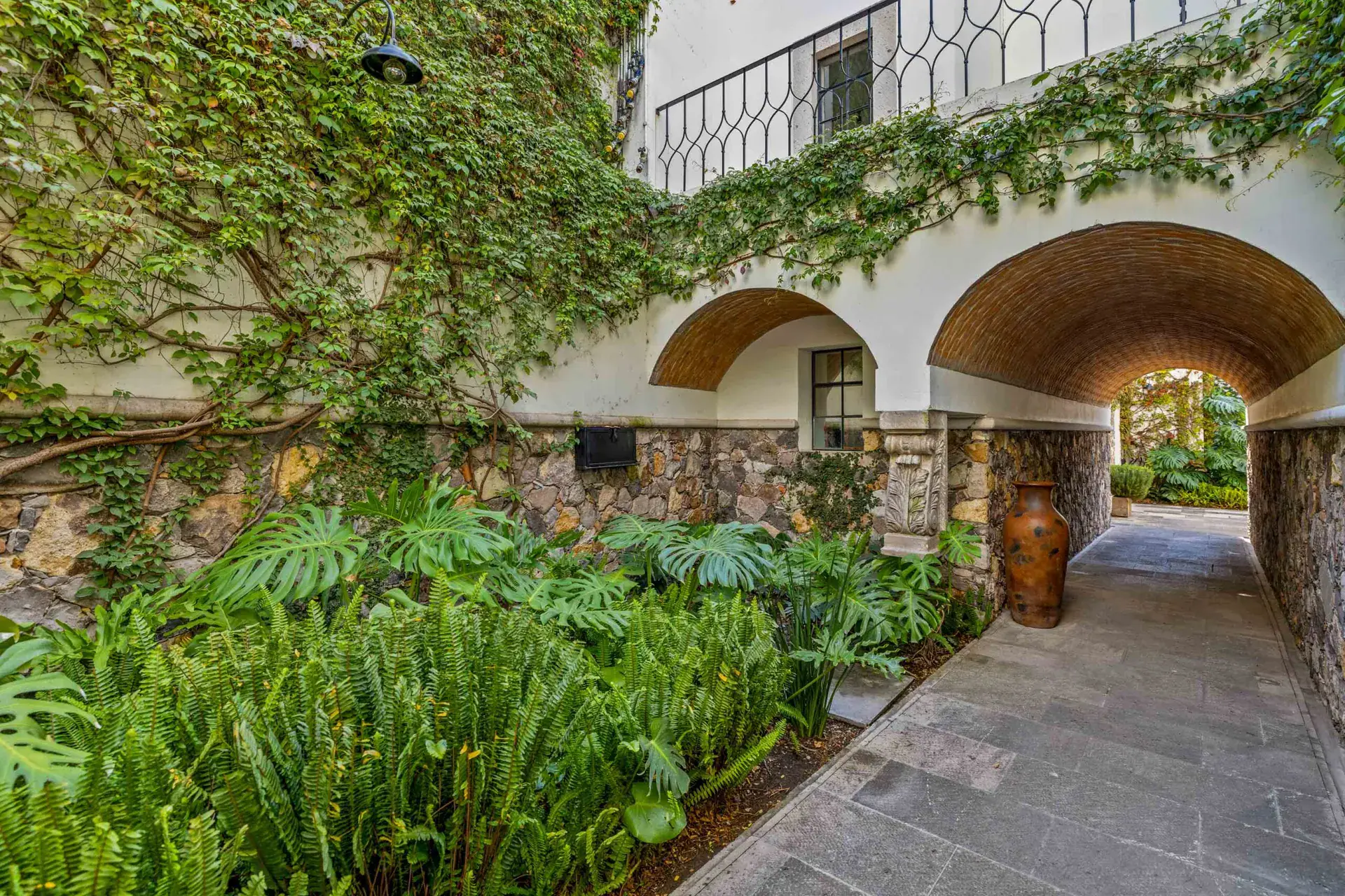 Casa Amoray, vine-covered stone arch over a garden path, San Miguel de Allende