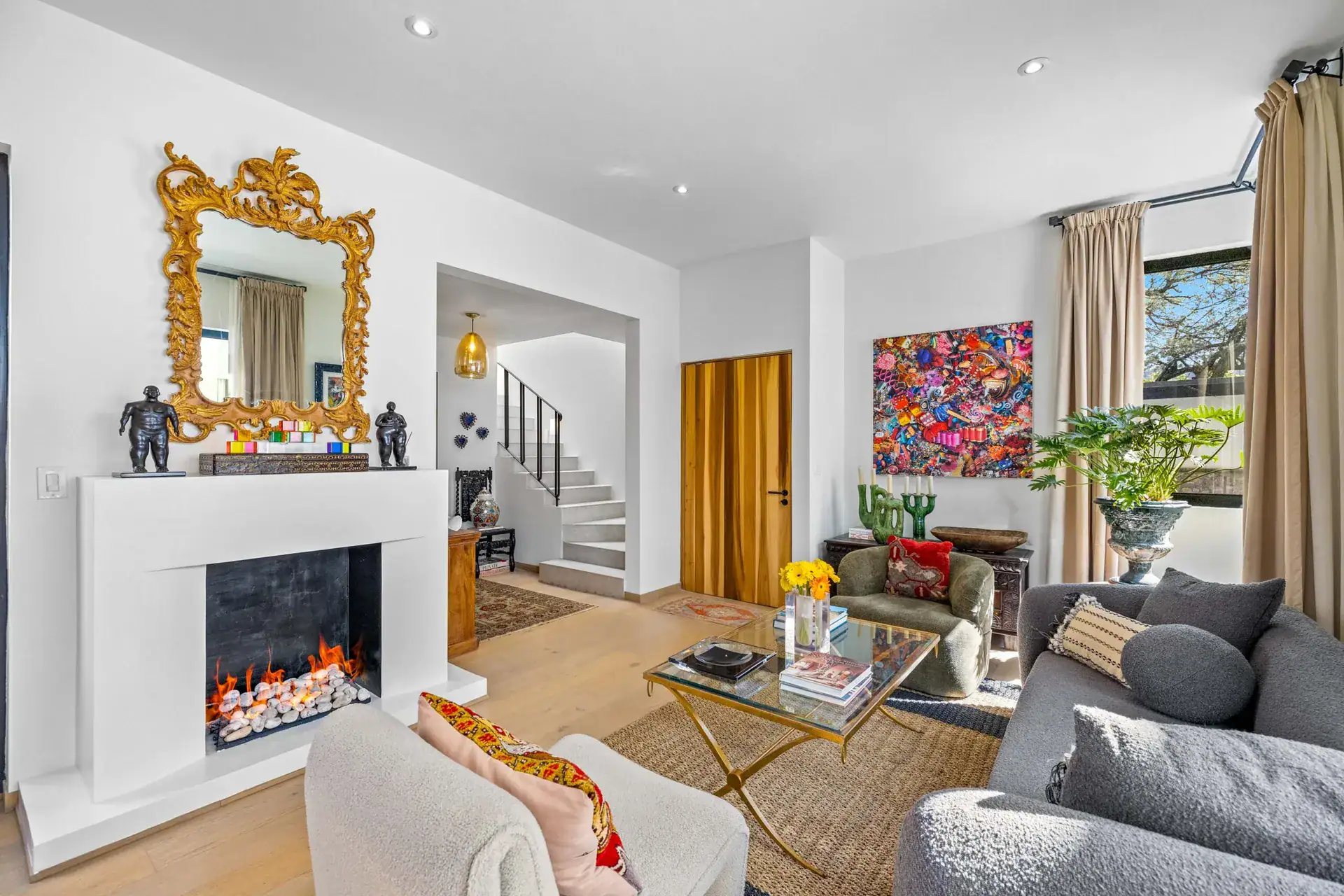 Casa Amoray, sitting area with a gold mirror and a white fireplace, San Miguel de Allende