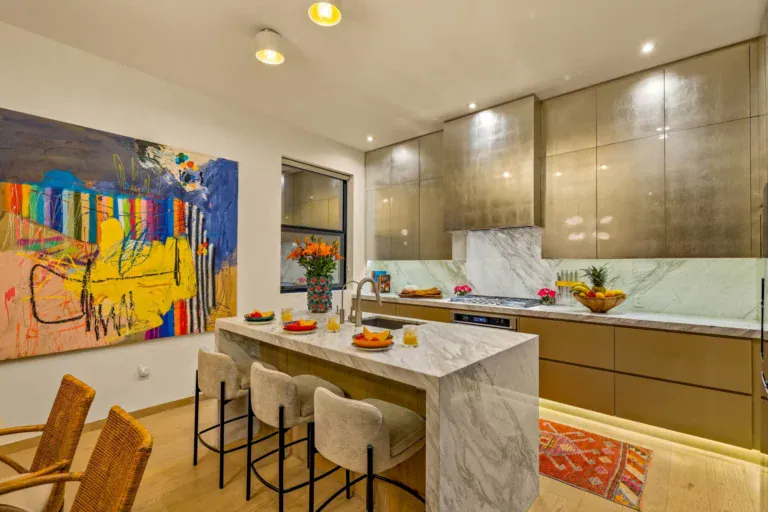 Casa Amoray, kitchen with a marble island and a large colorful painting, San Miguel de Allende