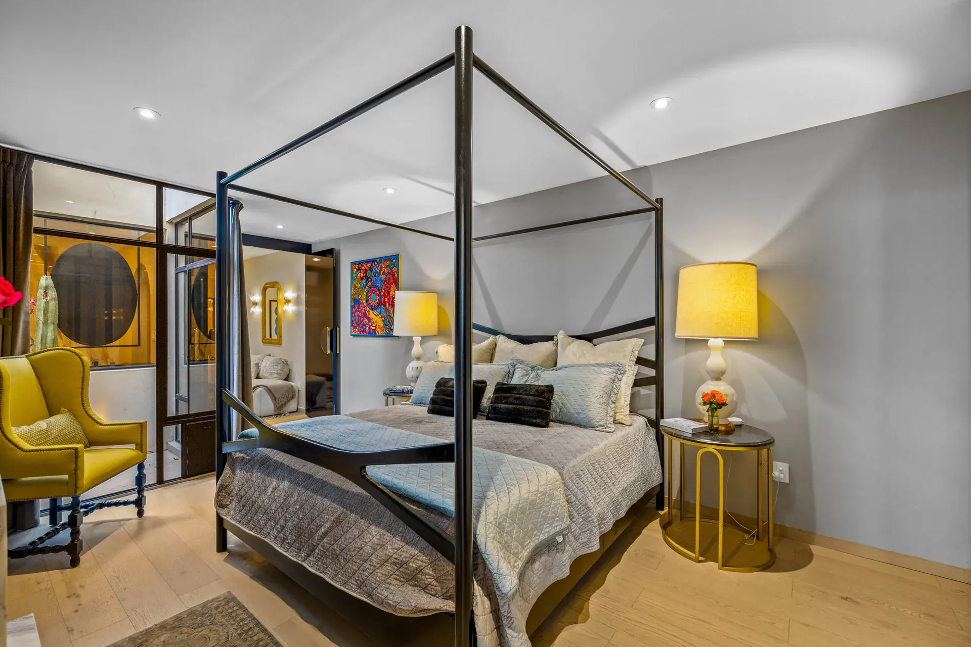Casa Amoray, primary bedroom with a four-poster bed and a yellow armchair, San Miguel de Allende